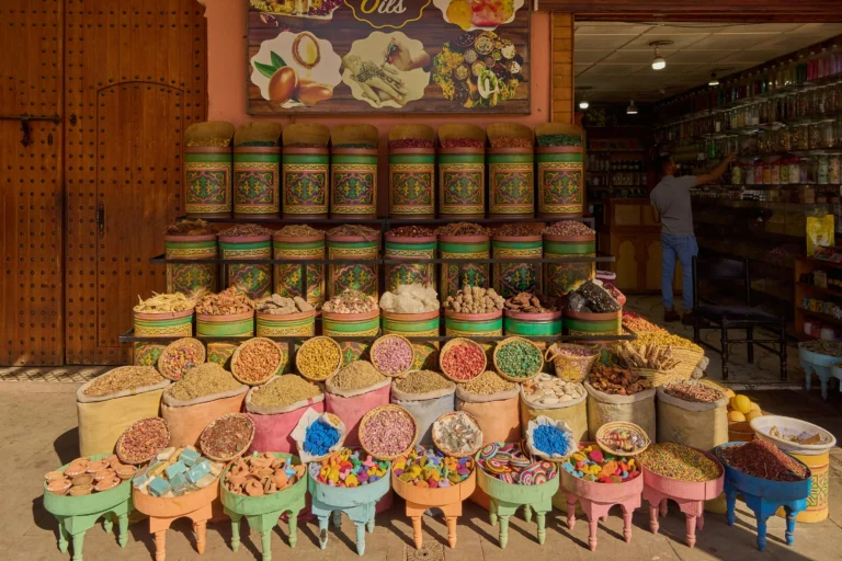 Colorful display of spices, powders, and herbs in a traditional Moroccan apothecary.