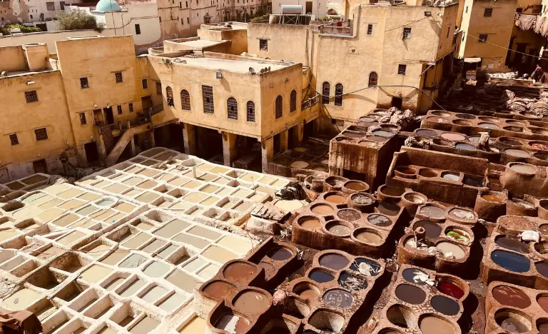 Aerial view of the leather tanneries in Marrakech with many circular vats.