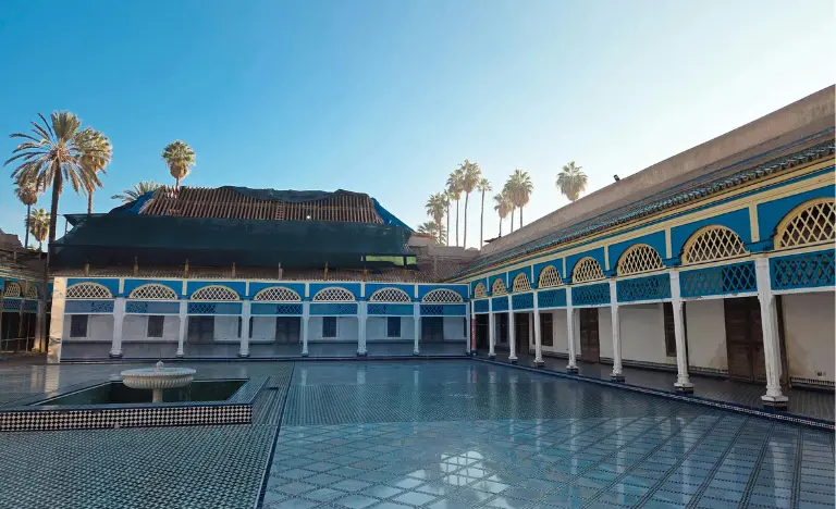 The blue and white tiled courtyard of Bahia Palace under a clear blue sky.