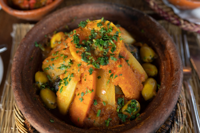 A delicious traditional Berber vegetable tagine served in a clay cooking pot.