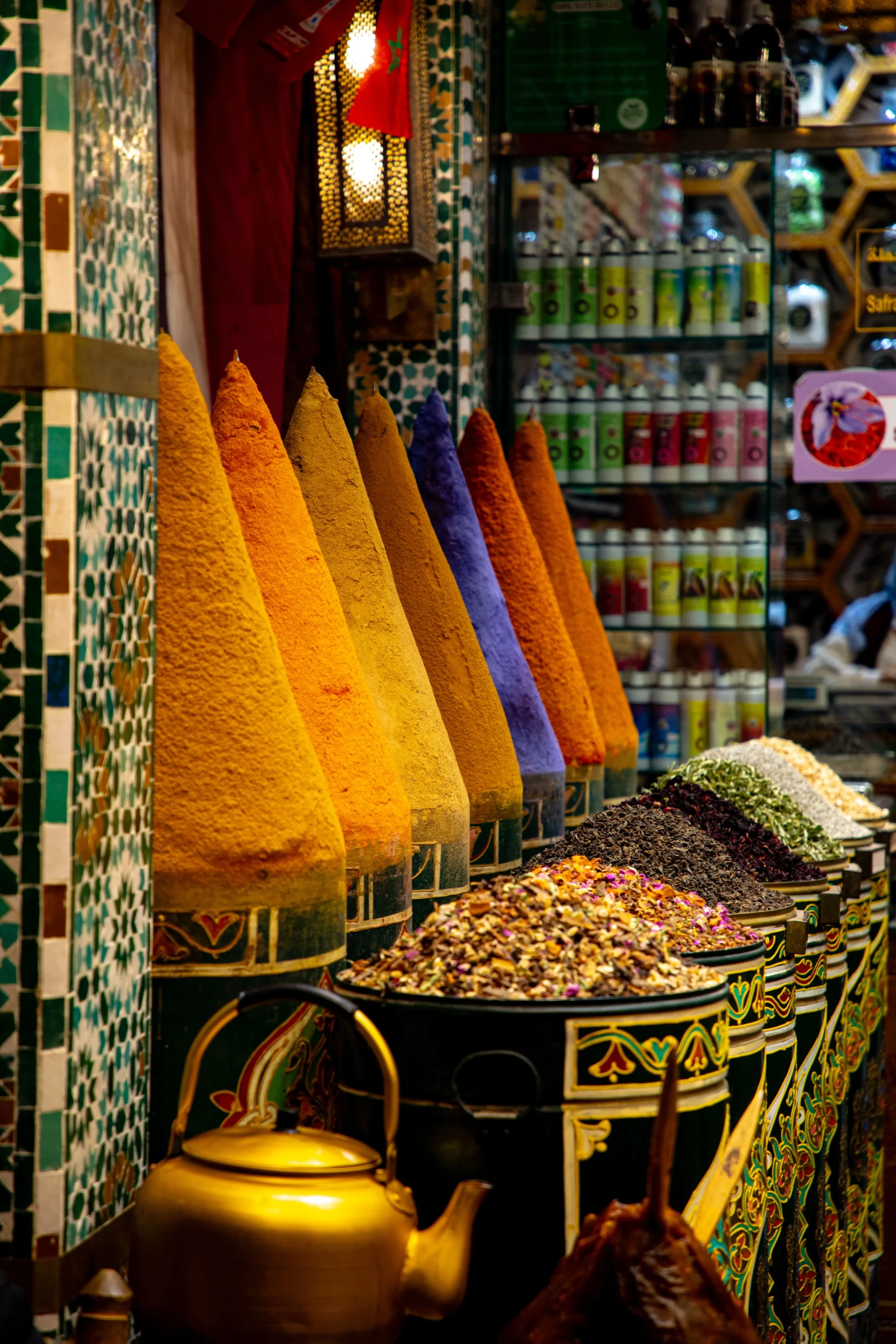 Cones of colorful spices and dried herbal teas at a traditional herbalist in the Marrakech souk