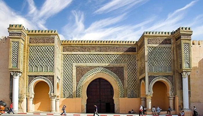 an image of Bab Mansour gate in Meknes at golden hour